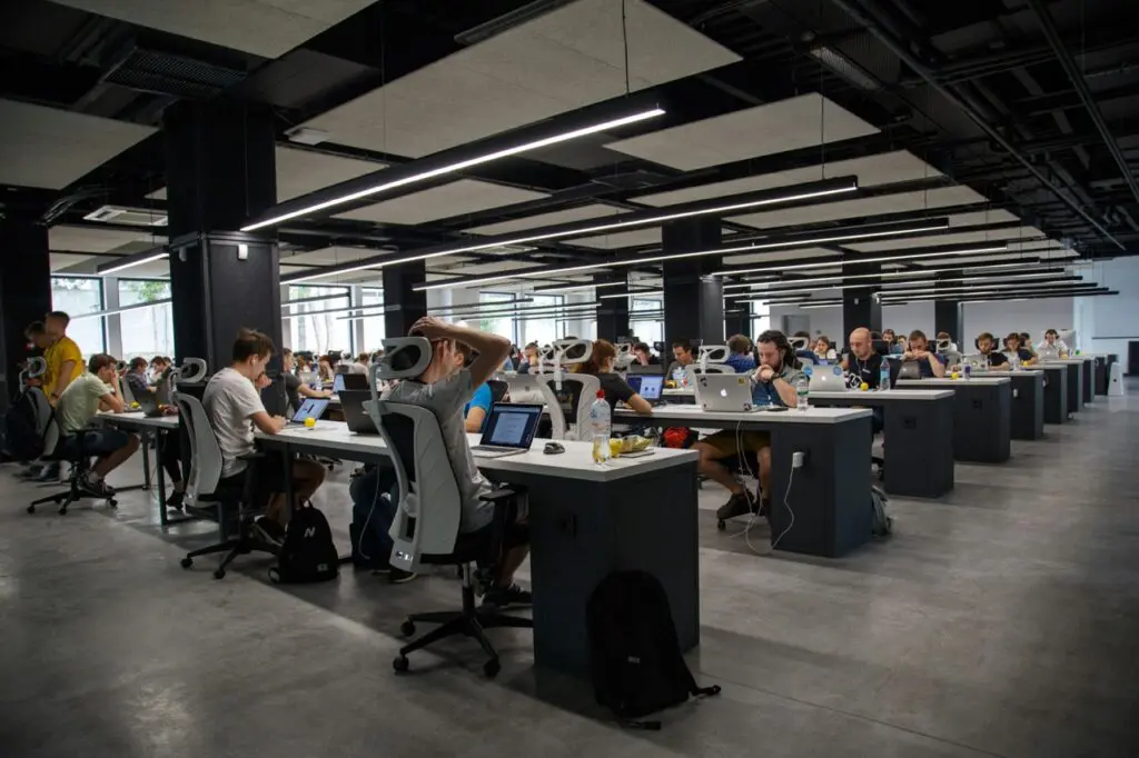 Picture showing people in open space office on computers