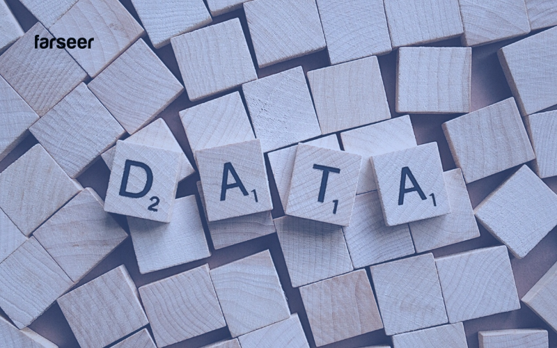 Wooden tiles spelling “DATA” surrounded by chaos – reflecting the data fragmentation challenges in Build vs Buy Software decisions.