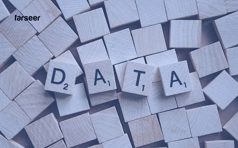 Wooden tiles spelling “DATA” surrounded by chaos – reflecting the data fragmentation challenges in Build vs Buy Software decisions.
