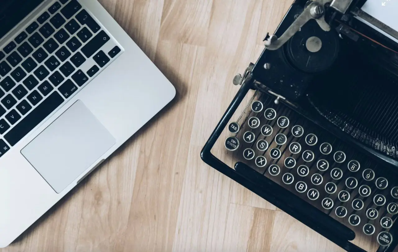 laptop and old typewriter representing corporate Financial planning 