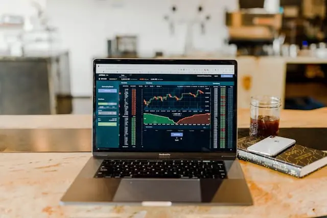 a laptop on a desk displaying two types of charts