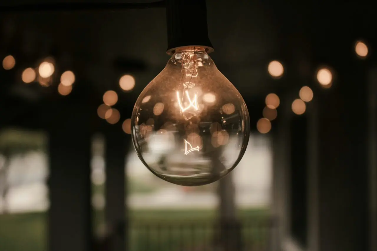 A close-up of a glowing vintage light bulb hanging in a dim room, symbolizing clarity and innovation—perfect visual metaphor for enterprise software for finance driving smarter decisions.