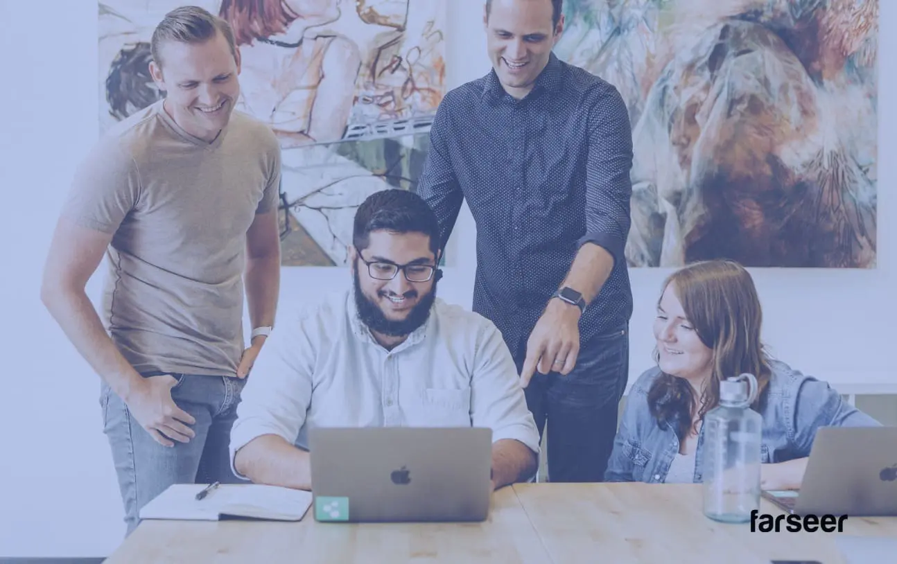 Finance team collaborating over a laptop – showcasing decision making in fp&a metrics