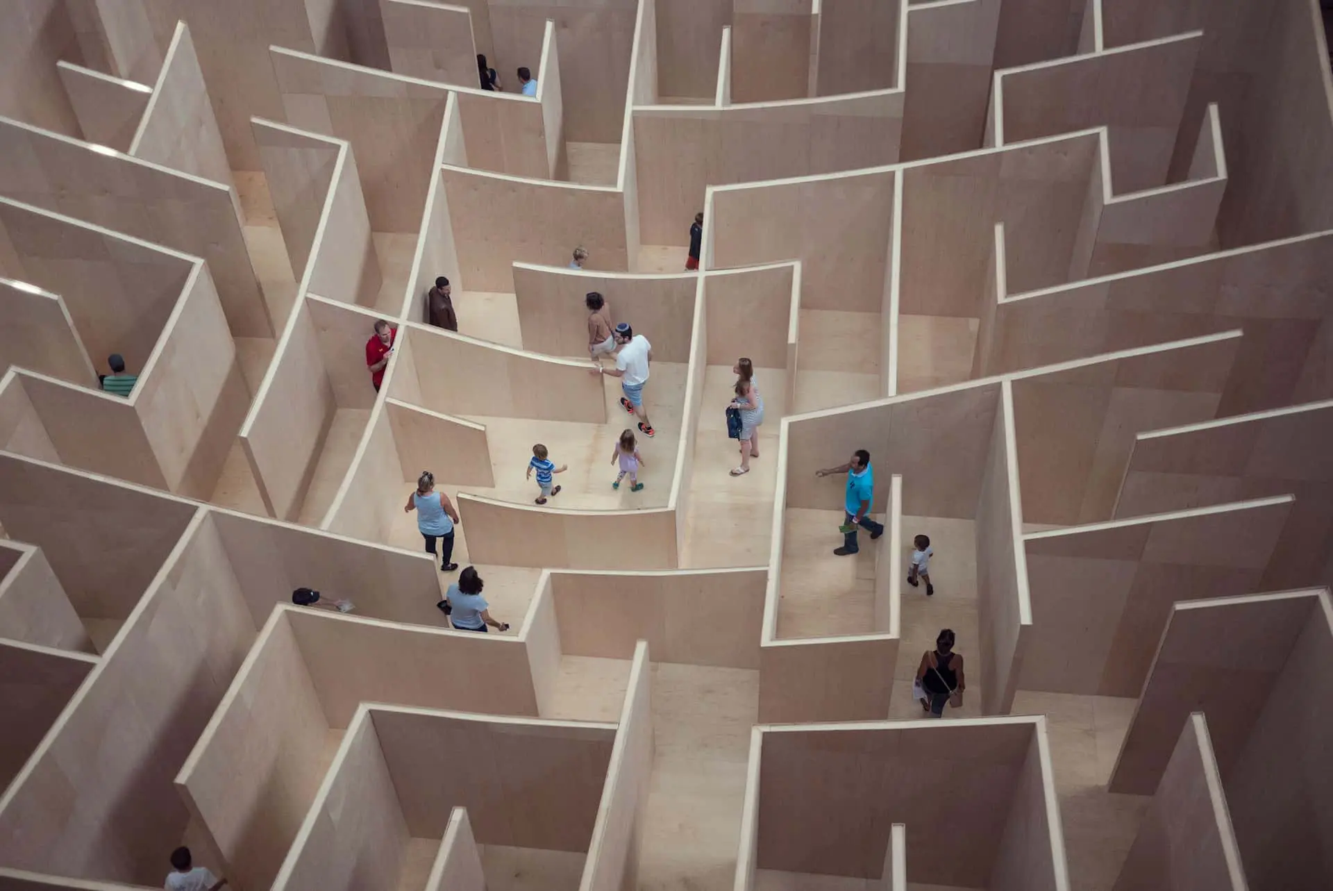 Aerial view of people lost in a wooden maze, representing how broken enterprise software and Excel-based planning trap teams in complexity.