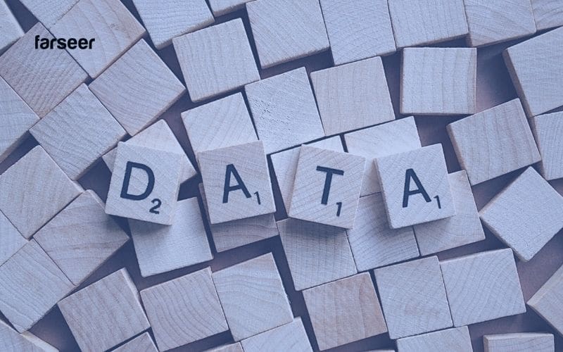 Wooden tiles spelling “DATA” surrounded by chaos – reflecting the data fragmentation challenges Profitability Planning