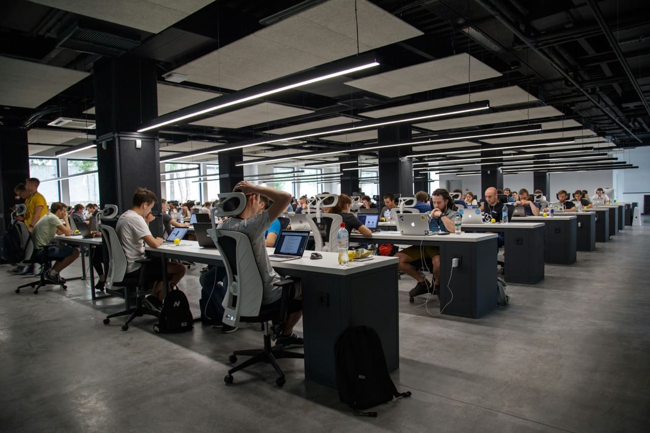 Picture showing people in open space office on computers