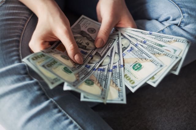 a man holding cash in his hands