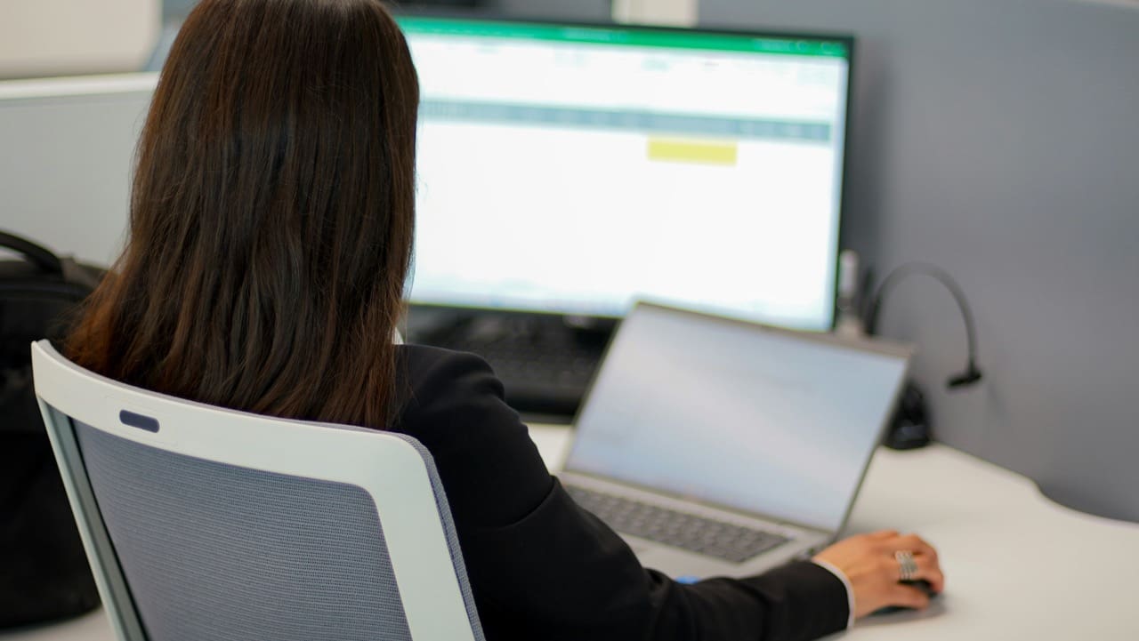 woman sitting at computer with financial consolidation