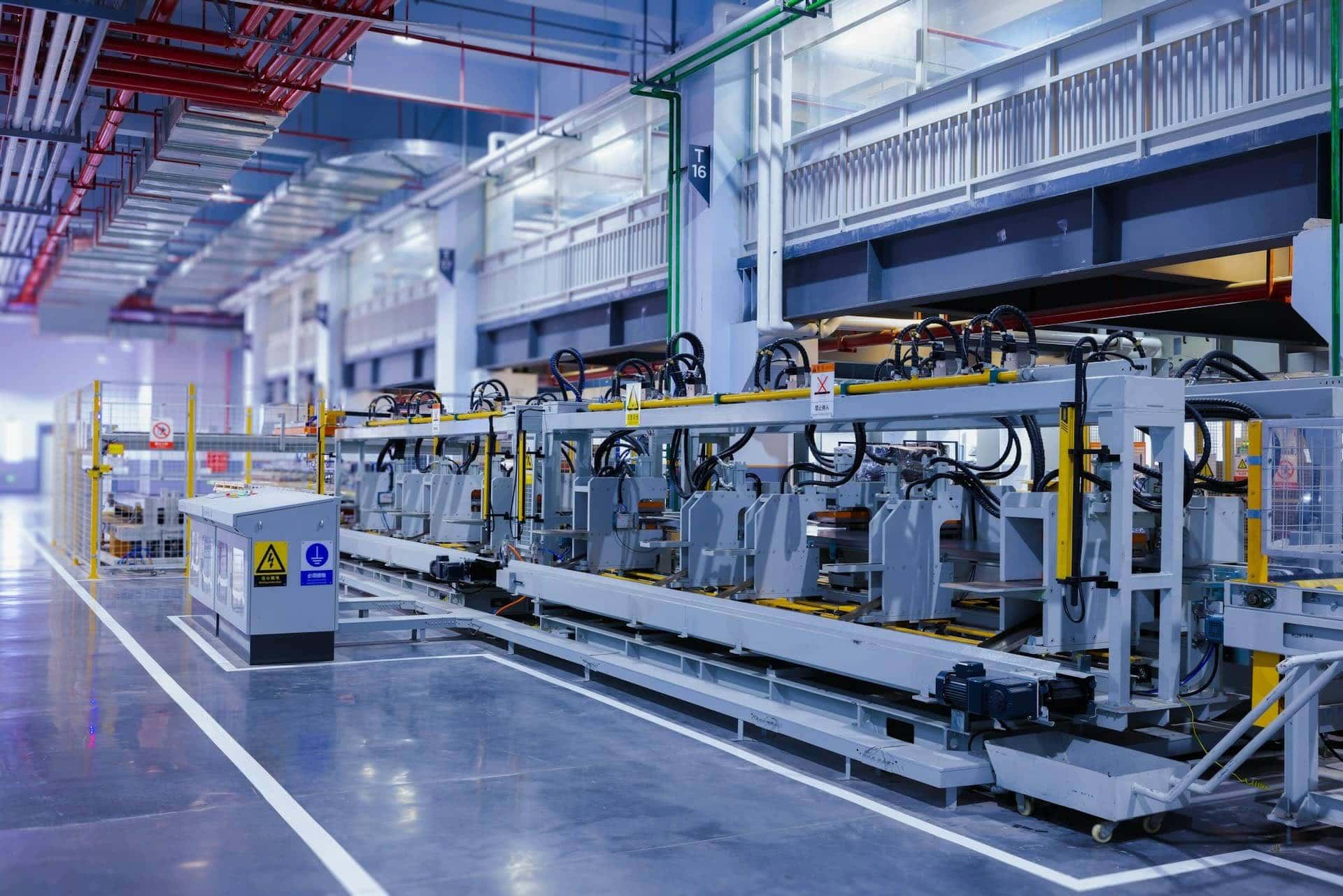 Modern automated manufacturing line in a clean, well-lit factory environment, representing industrial production or CAPEX investment.